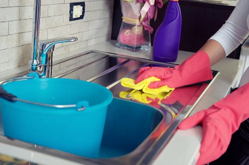 Local cleaners dusting and vacuuming a London home