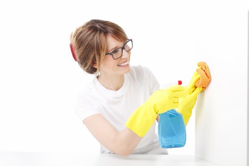 Local technician cleaning a sofa in a shared living space