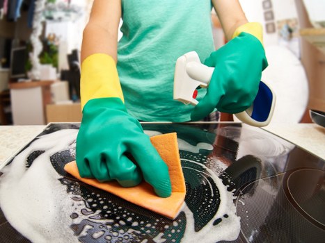Local cleaner tidying a kitchen in Elephant and Castle