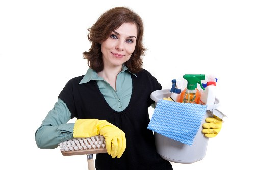 Cleaner treating a staircase carpet in a South London property